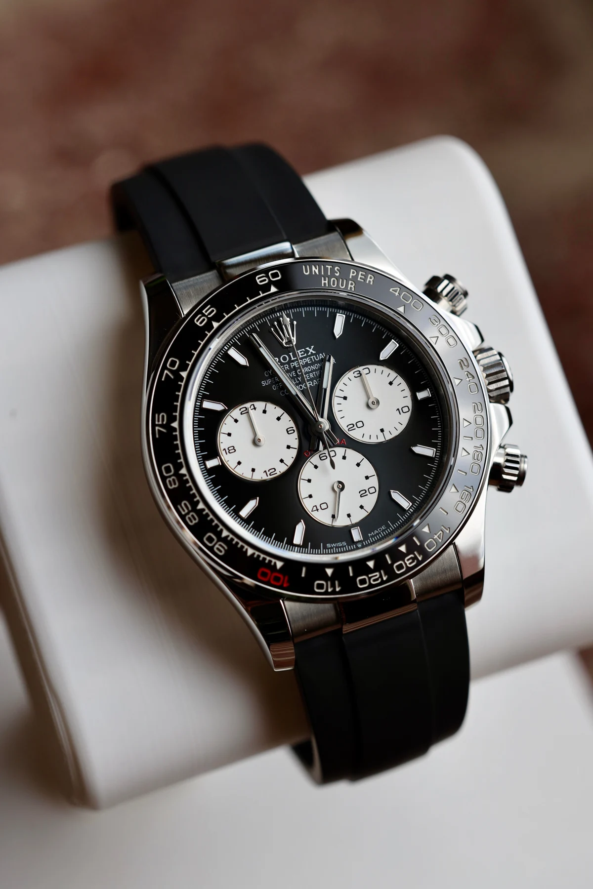 Black dial racing chronograph on rubber — full watch view