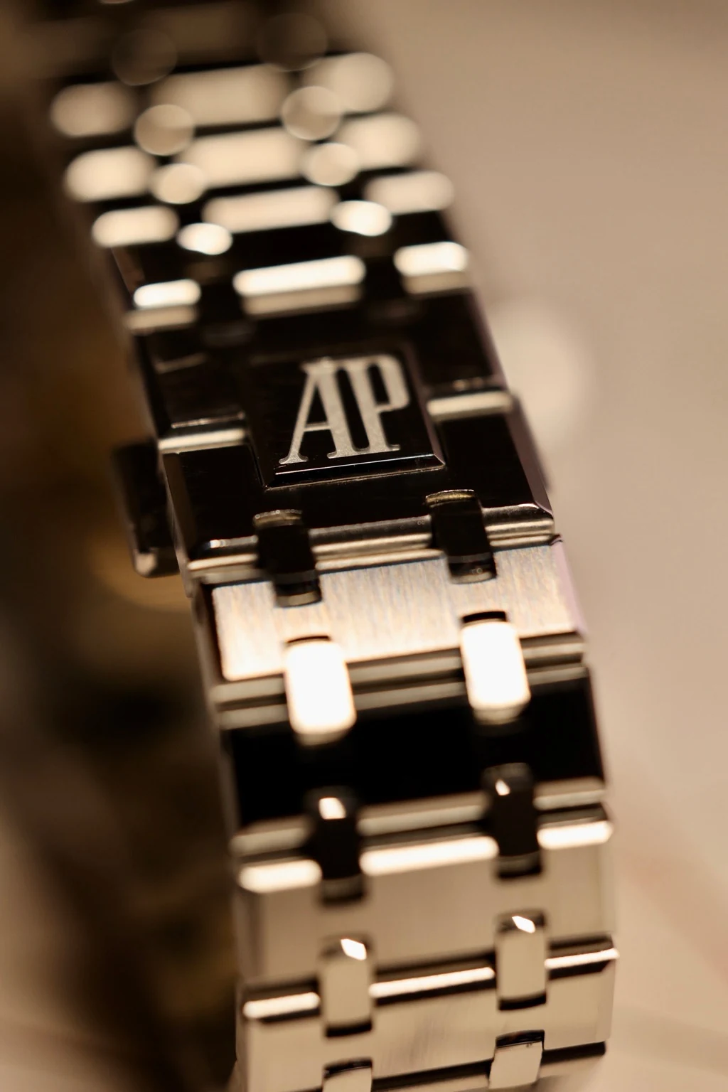 Polished bracelet clasp and surrounding links, photographed from above