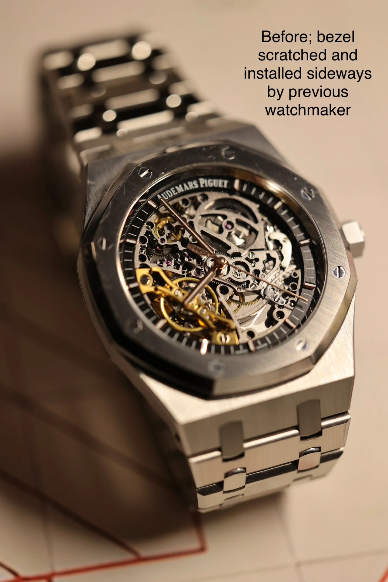 Skeleton-dial watch before service, with the original photograph’s note about the bezel